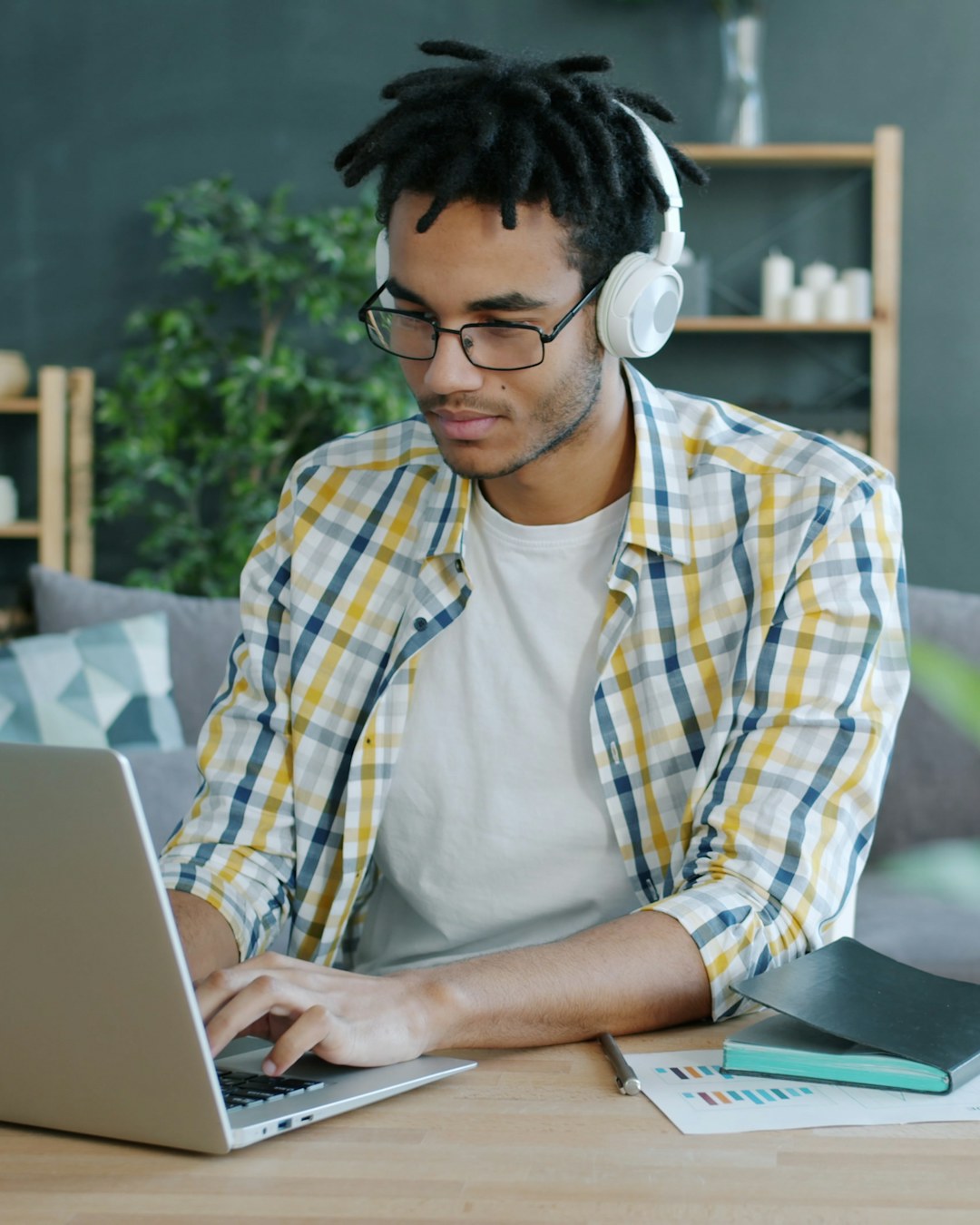A learner practises calmly at his laptop, headset on